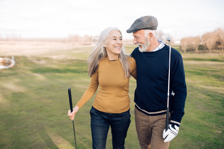 Senior couple going to play golf.