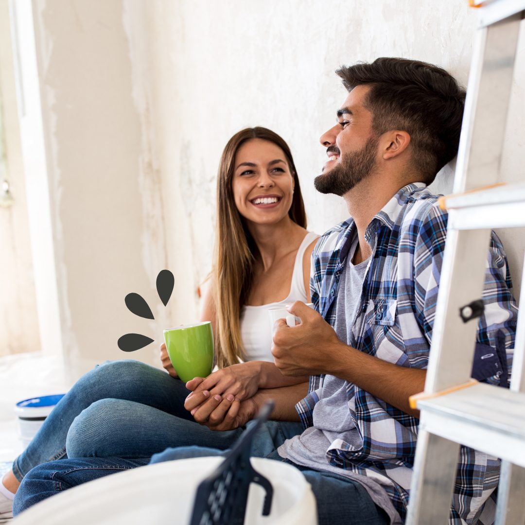 HELOCs Couple sitting against the wall resting from making home improvements