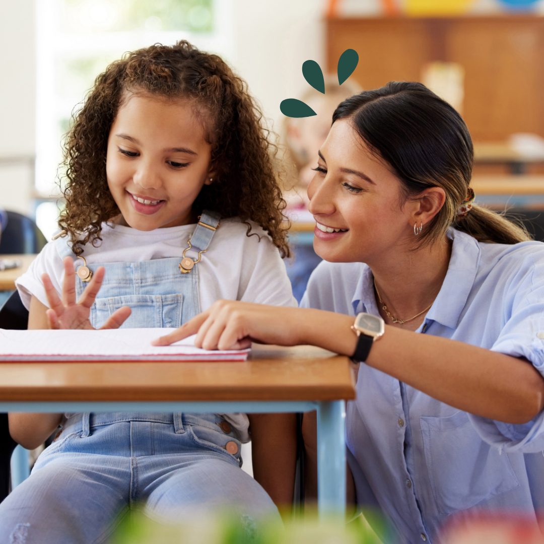 ECU Membership Qualifications Teacher assisting young student with assignment