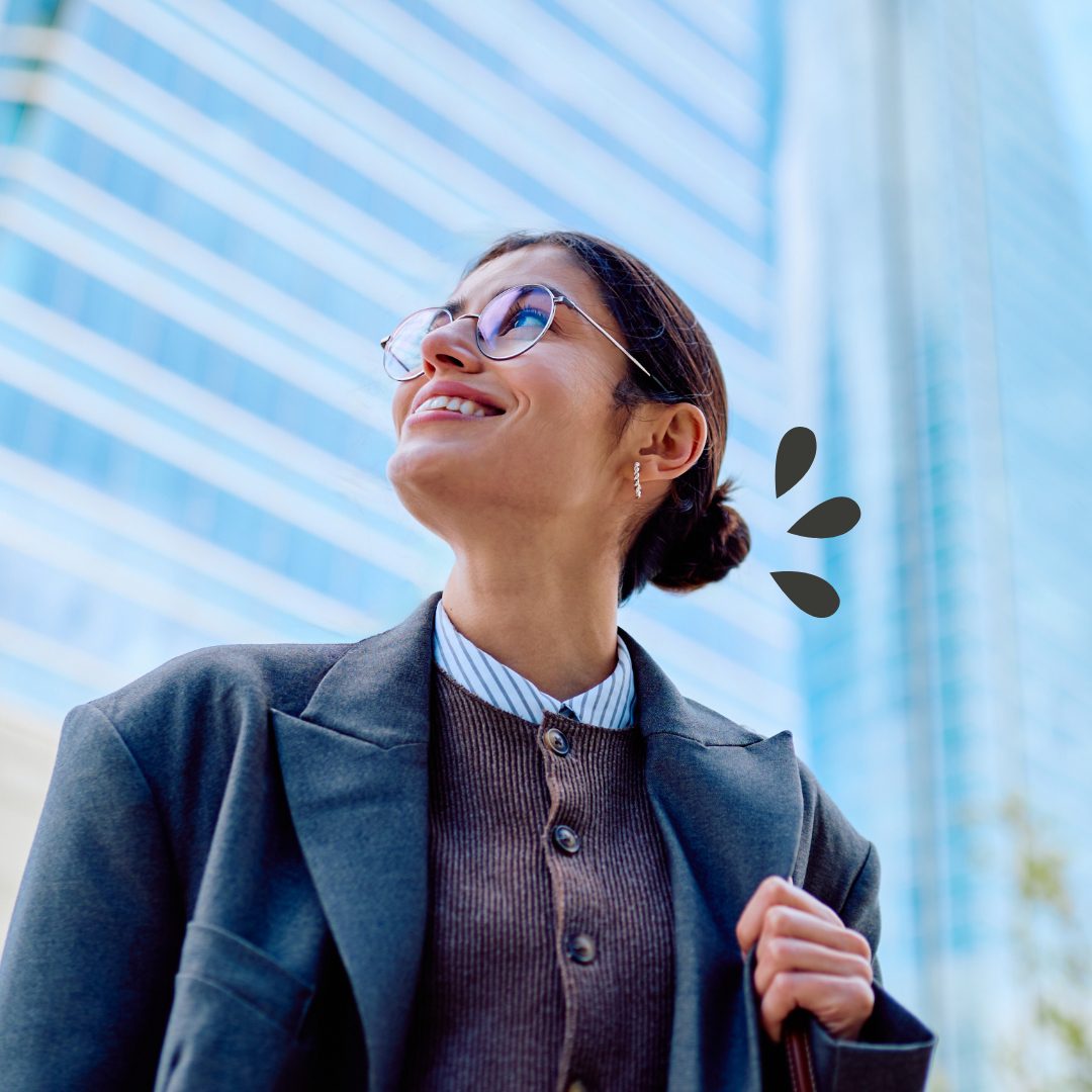 Investments Woman in professional attire looking up in a downtown city
