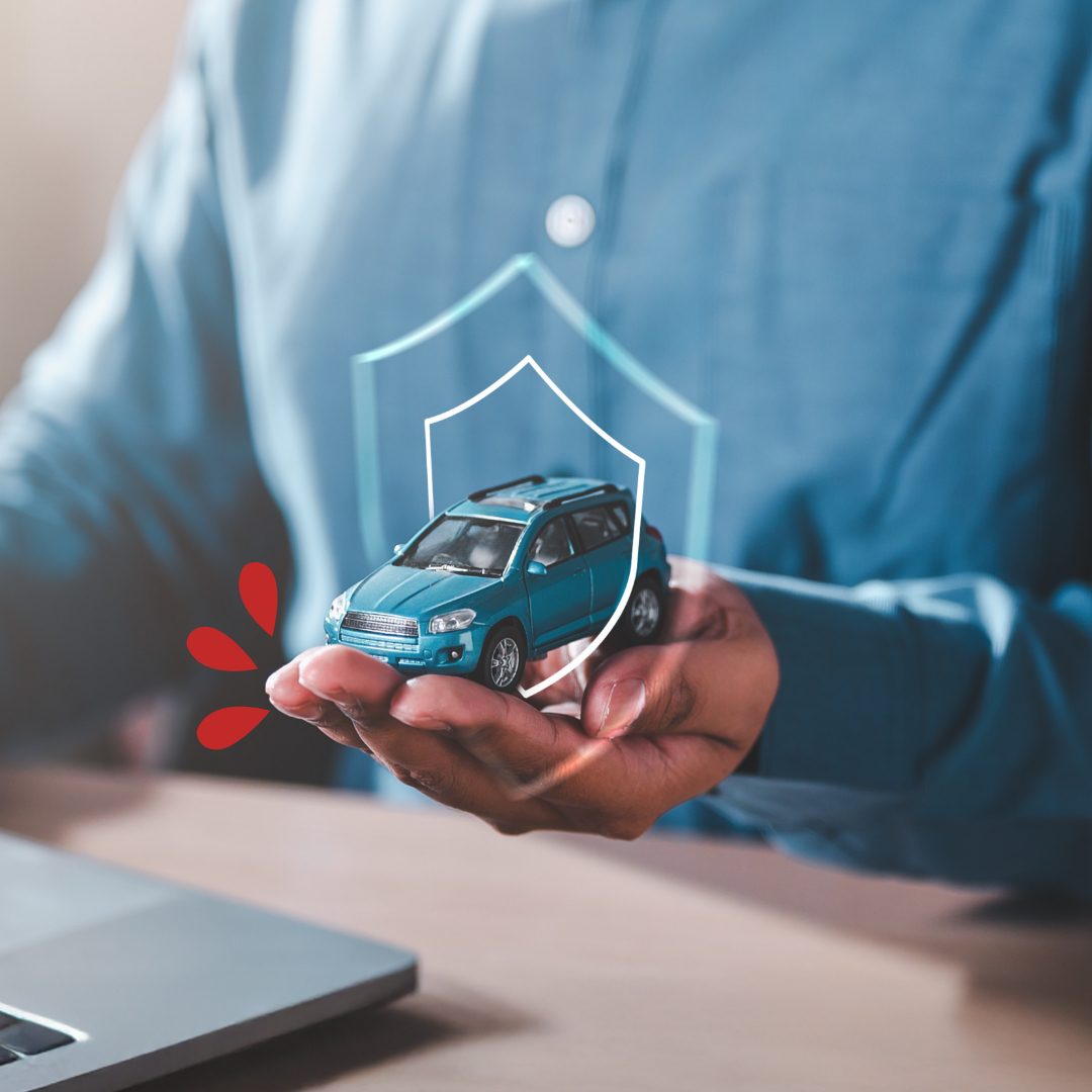Tiny car in the palm of a mans hand with a shield icon