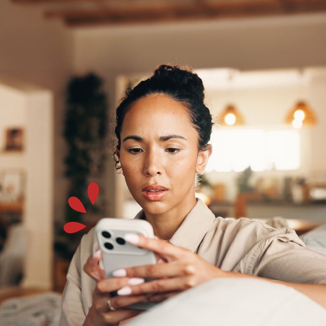 Fraud and Scam Prevention Woman looking at her phone in her home