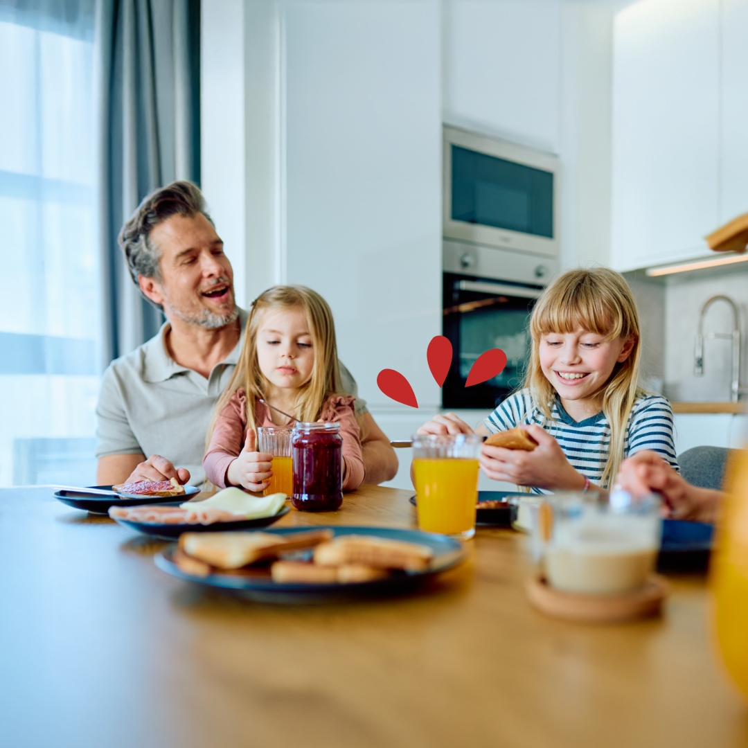 Skip-a-Pay Father and young daughters having breakfast in the kitchen