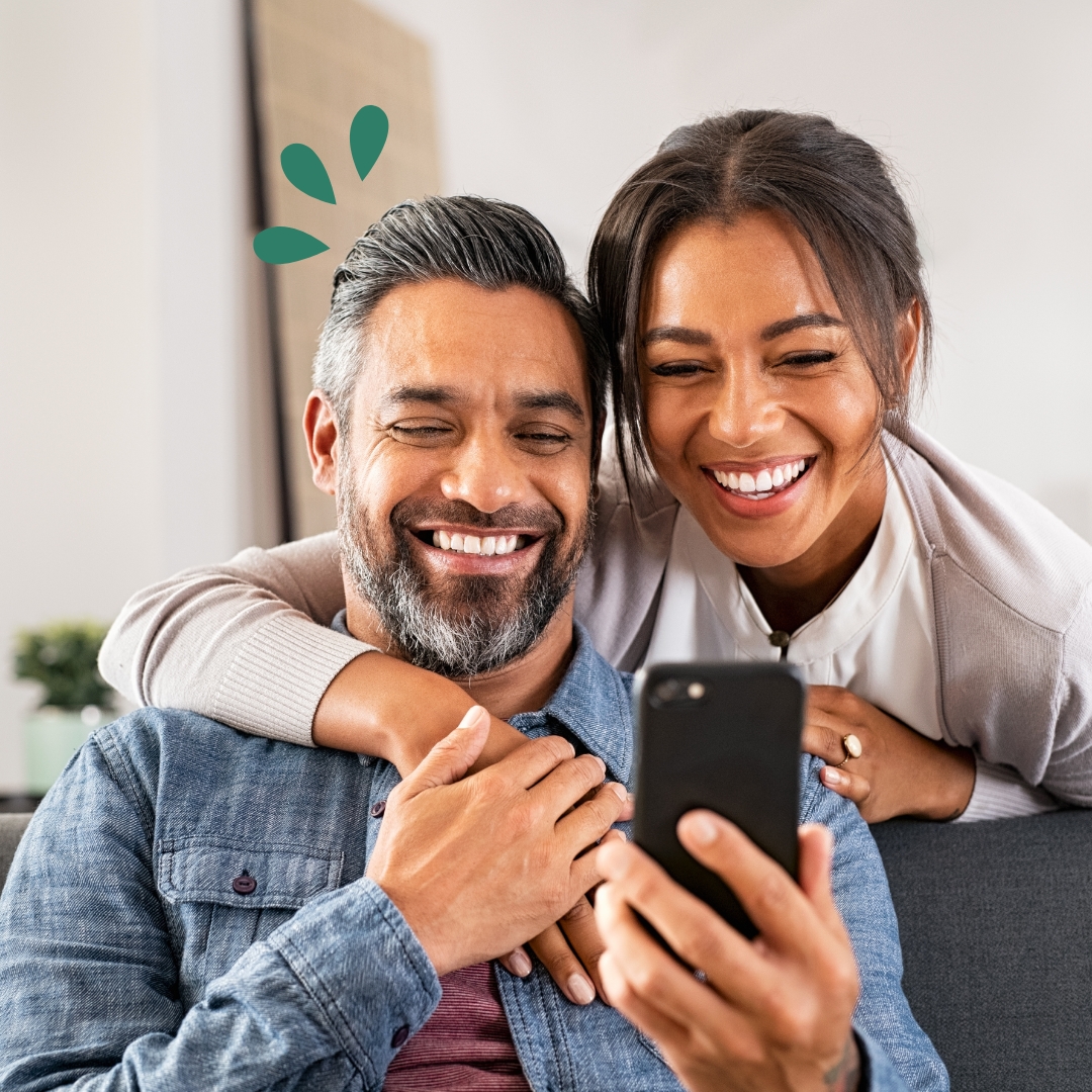 Bill Pay Man with wife using a device to make bill payments